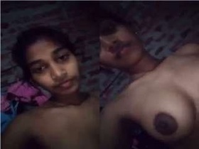 Lonely girl bares her breasts and intimate area