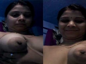Bhabhi's smiling face as she flaunts her breasts and vulva