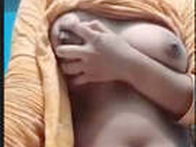 This video features a stunning Indian girl who proudly displays her ample bosom