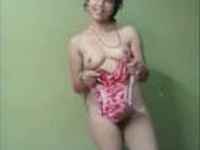 A beautiful wife strips down to her lingerie while changing clothes