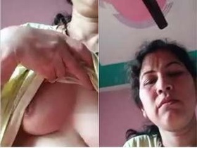 Assami Budi flaunts her big tits in this steamy video
