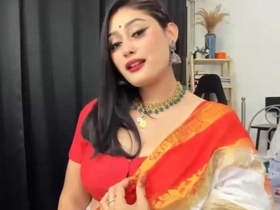 Anna, a cute babe, flaunts her sexy figure in a bright orange sari