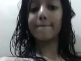 A sweet young woman in the bathroom, uncovered in a video