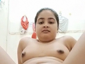 A young Indian woman in the bathtub, completely naked and alone
