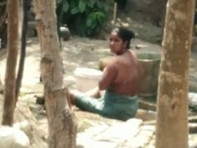 Hidden camera captures Indian aunt's nude outdoor bath