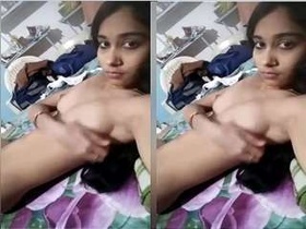A seductive woman flaunts her breasts and masturbates with her hands