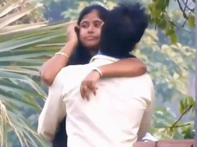 Kissing and cuddling in the park with a sweet couple