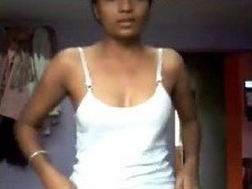 Desi girl takes selfies while undressing in bedroom