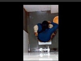 Indian girl changes pad in bathroom