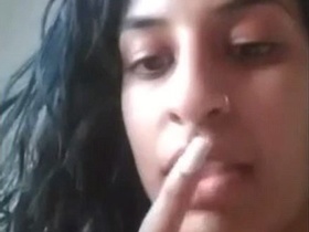 The girl's face is sexy as she fingers herself hard