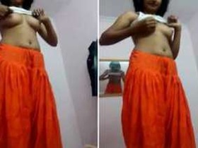 Desi teen struggles to put on her skirt in front of the camera